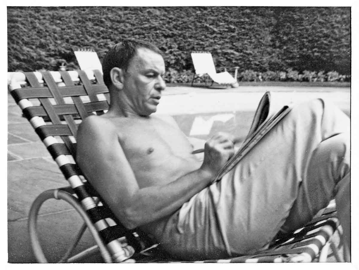 Frank Sinatra doing the crossword at Bennett's country home, by Phyllis Cerf, courtesy Christopher and Jonathan Cerf.